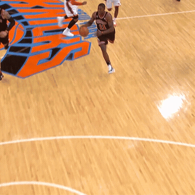 A Basketball Player With The Number 11 On His Jersey Is Dribbling The Ball GIF