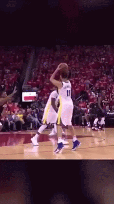 A Basketball Player With The Number 11 On His Jersey Is Playing Basketball GIF
