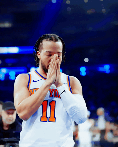 A Basketball Player With The Number 11 On His Jersey Praying GIF
