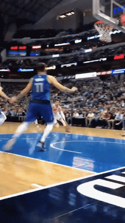 A Basketball Player With The Number 11 On The Back Of His Jersey Is Jumping In The Air GIF