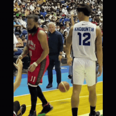 A Basketball Player With The Number 12 On His Back Is Talking To Another Player GIF