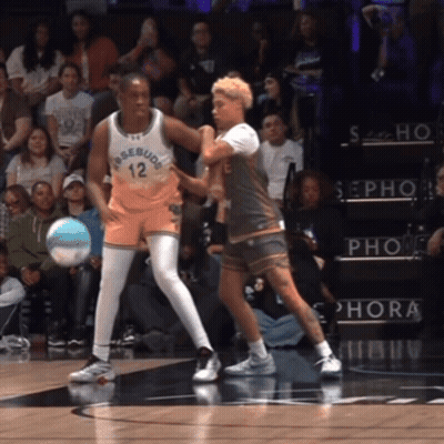 A Basketball Player With The Number 12 On His Jersey Is Playing Against Another Player GIF