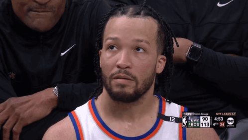 A Basketball Player With The Number 12 On His Jersey Looks Up At The Sky GIF