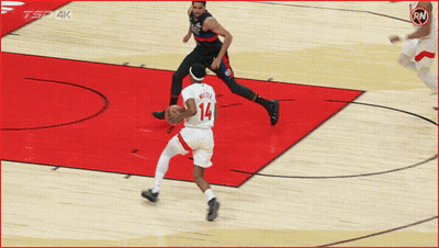 A Basketball Player With The Number 14 On His Jersey Dribbles The Ball GIF