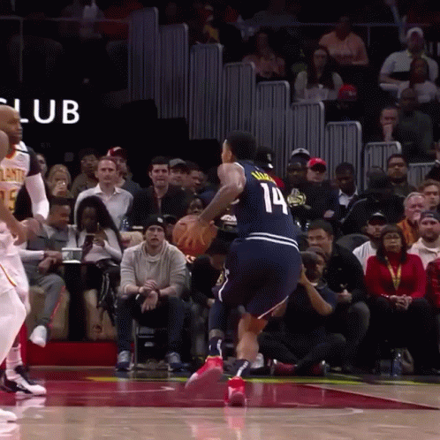 A Basketball Player With The Number 14 On His Jersey Is Dribbling The Ball GIF