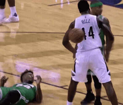 A Basketball Player With The Number 14 On His Jersey Is Holding A Basketball GIF