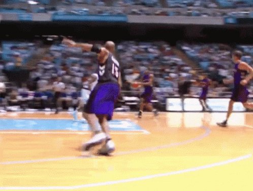 A Basketball Player With The Number 15 On His Jersey Dribbles The Ball GIF