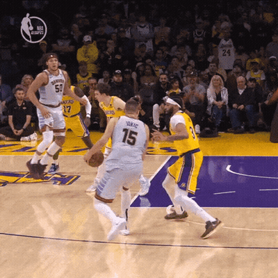 A Basketball Player With The Number 15 On His Jersey Dribbles The Ball GIF