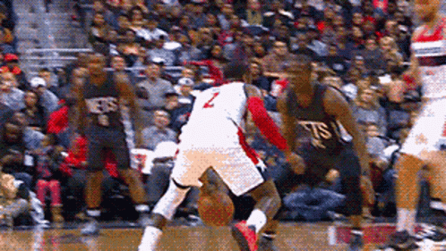 A Basketball Player With The Number 2 On His Jersey Is Dribbling The Ball GIF