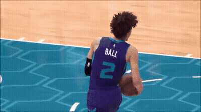 A Basketball Player With The Number 2 On His Jersey Is Running With The Ball GIF