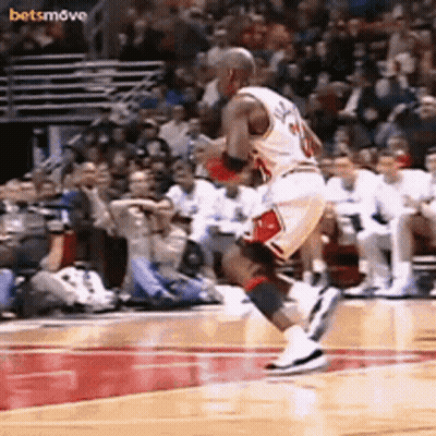 A Basketball Player With The Number 20 On His Jersey Is Jumping In The Air GIF