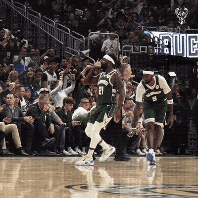 A Basketball Player With The Number 21 On His Jersey Is Running On The Court GIF