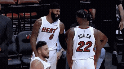 A Basketball Player With The Number 22 On His Back Talks To Another Player GIF