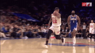 A Basketball Player With The Number 22 On His Jersey Dribbles The Ball GIF