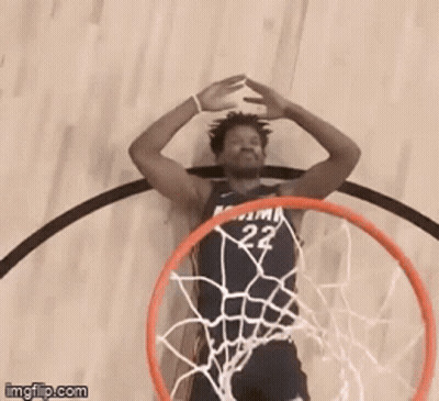 A Basketball Player With The Number 22 On His Jersey Is Going Through A Hoop GIF
