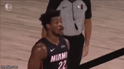 A Basketball Player With The Number 22 On His Jersey Is Standing On The Court . GIF