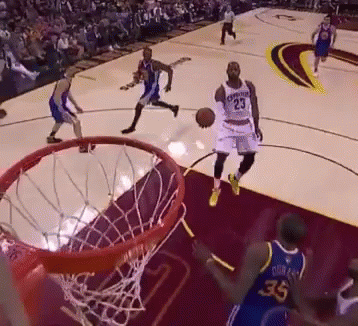 A Basketball Player With The Number 23 On His Jersey Goes For A Dunk GIF