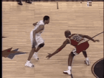 A Basketball Player With The Number 23 On His Jersey Is Dribbling The Ball GIF