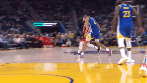 A Basketball Player With The Number 23 On His Jersey Is Dribbling The Ball GIF
