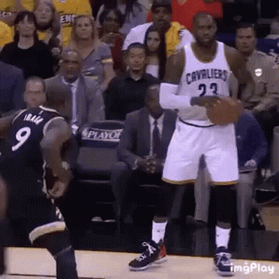 A Basketball Player With The Number 23 On His Jersey Is Holding A Basketball . GIF