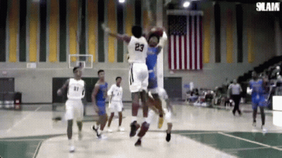 A Basketball Player With The Number 23 On His Jersey Is Jumping Over Another Player GIF