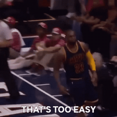 A Basketball Player With The Number 23 On His Jersey Is Kneeling Down On The Court While A Crowd Watches . GIF