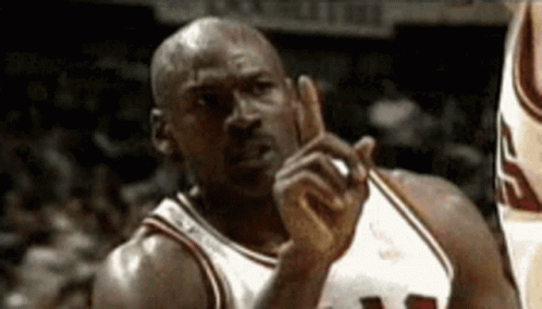 A Basketball Player With The Number 23 On His Jersey Is Pointing GIF