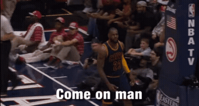 A Basketball Player With The Number 23 On His Jersey Is Standing On The Court . GIF