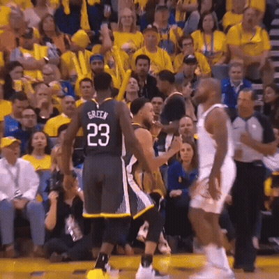 A Basketball Player With The Number 23 On His Jersey Is Talking To Another Player On The Court . GIF