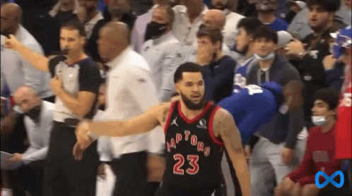 A Basketball Player With The Number 23 On His Jersey Stands In Front Of A Crowd Of People . GIF