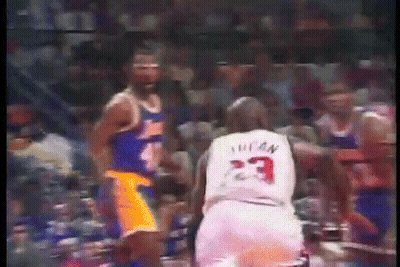 A Basketball Player With The Number 23 On His Jersey Stands Next To Another Player . GIF