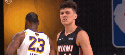 A Basketball Player With The Number 23 On His Jersey Stands Next To Another Player GIF