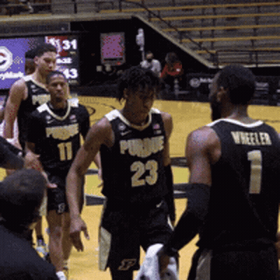 A Basketball Player With The Number 23 On His Jersey Talks To Another Player GIF