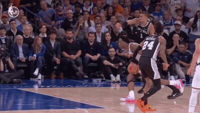 A Basketball Player With The Number 24 On His Back Dribbles The Ball GIF