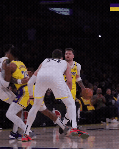 A Basketball Player With The Number 24 On His Back Dribbles The Ball GIF