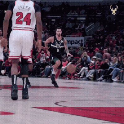 A Basketball Player With The Number 24 On His Jersey Dribbles The Ball GIF