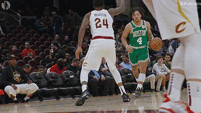 A Basketball Player With The Number 24 On His Jersey Dribbles The Ball GIF