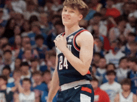 A Basketball Player With The Number 24 On His Jersey Stands In Front Of A Crowd GIF