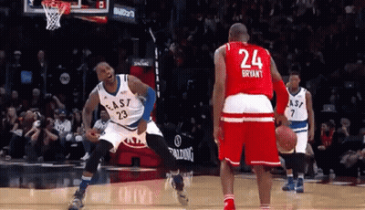 A Basketball Player With The Number 24 On His Jersey Stands Next To Another Player GIF