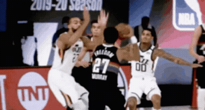 A Basketball Player With The Number 27 On His Jersey Is Being Blocked By Another Player GIF