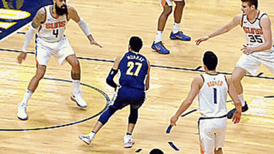 A Basketball Player With The Number 27 On His Jersey Is Playing Defense GIF