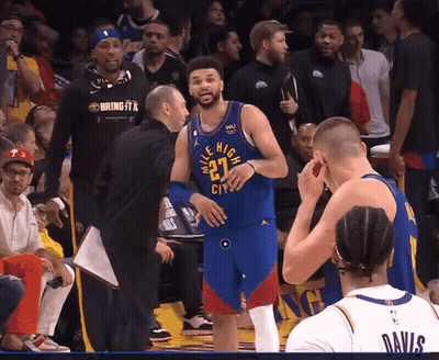 A Basketball Player With The Number 27 On His Jersey Talks To A Coach GIF