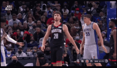 A Basketball Player With The Number 28 On His Jersey Stands In Front Of A Crowd GIF