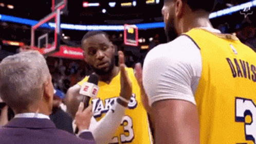 A Basketball Player With The Number 3 On His Jersey Is Being Interviewed By A Reporter GIF