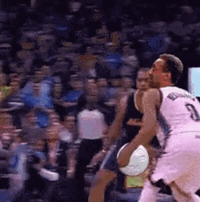 A Basketball Player With The Number 3 On His Jersey Is Dribbling A Basketball GIF