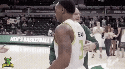 A Basketball Player With The Number 3 On His Jersey Is Hugging Another Player GIF