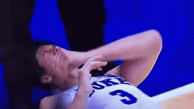 A Basketball Player With The Number 3 On His Jersey Is Laying On The Floor With His Head In His Hands . GIF