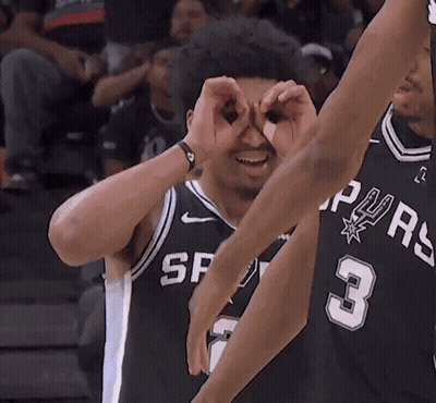 A Basketball Player With The Number 3 On His Jersey Looks Through His Hands GIF
