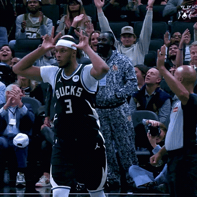 A Basketball Player With The Number 3 On His Jersey Stands In Front Of A Crowd GIF