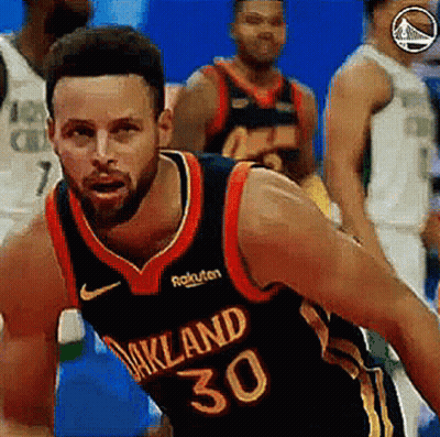 A Basketball Player With The Number 30 On His Jersey Is Dribbling The Ball . GIF